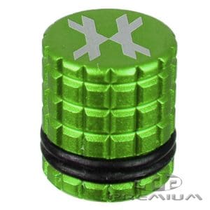 Black paintball fill nipple cover with green top and snowflake design, designed for paintball marker maintenance and refilling.