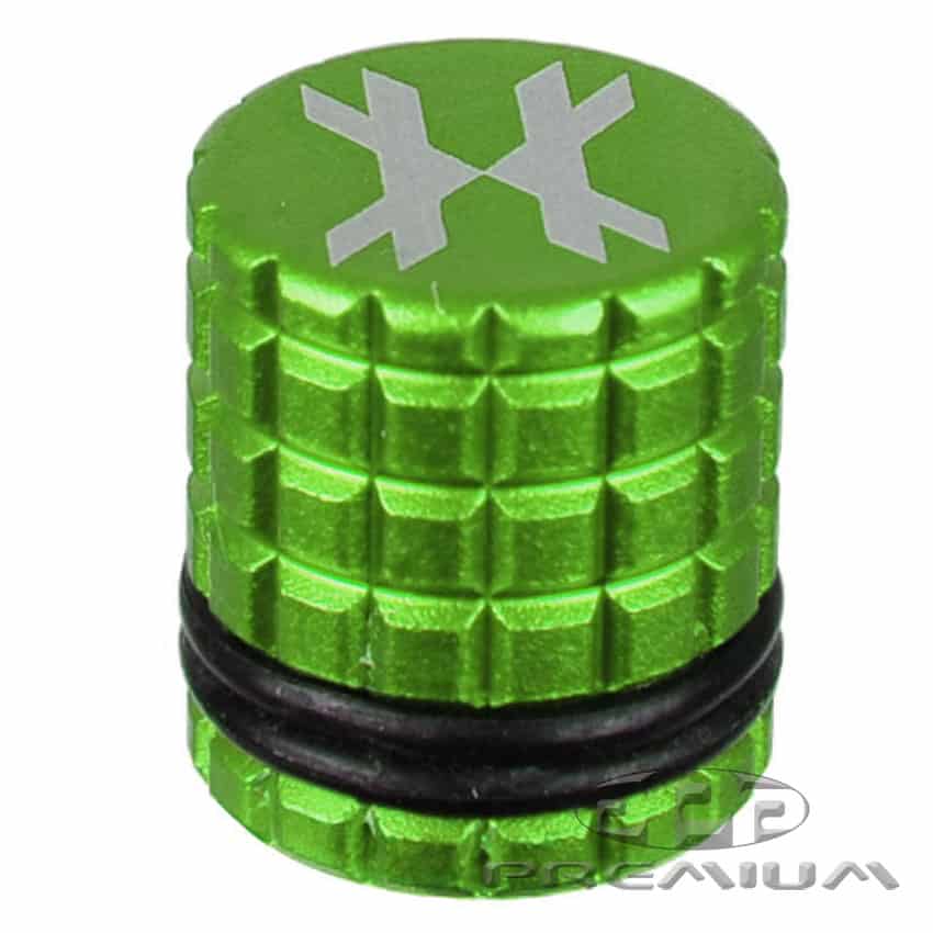 Black paintball fill nipple cover with green top and snowflake design, designed for paintball marker maintenance and refilling.
