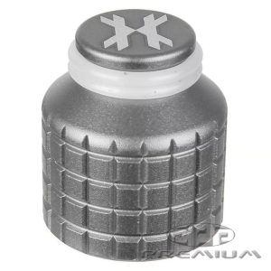 Close-up of a metallic paintball tank cap with textured grip and logo on top, used for securing paintball tanks during gameplay.