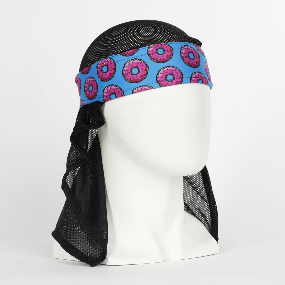 Colorful HK Army headwrap with donut pattern, designed for paintball players, featuring a vibrant blue background with pink donuts and black mesh material.
